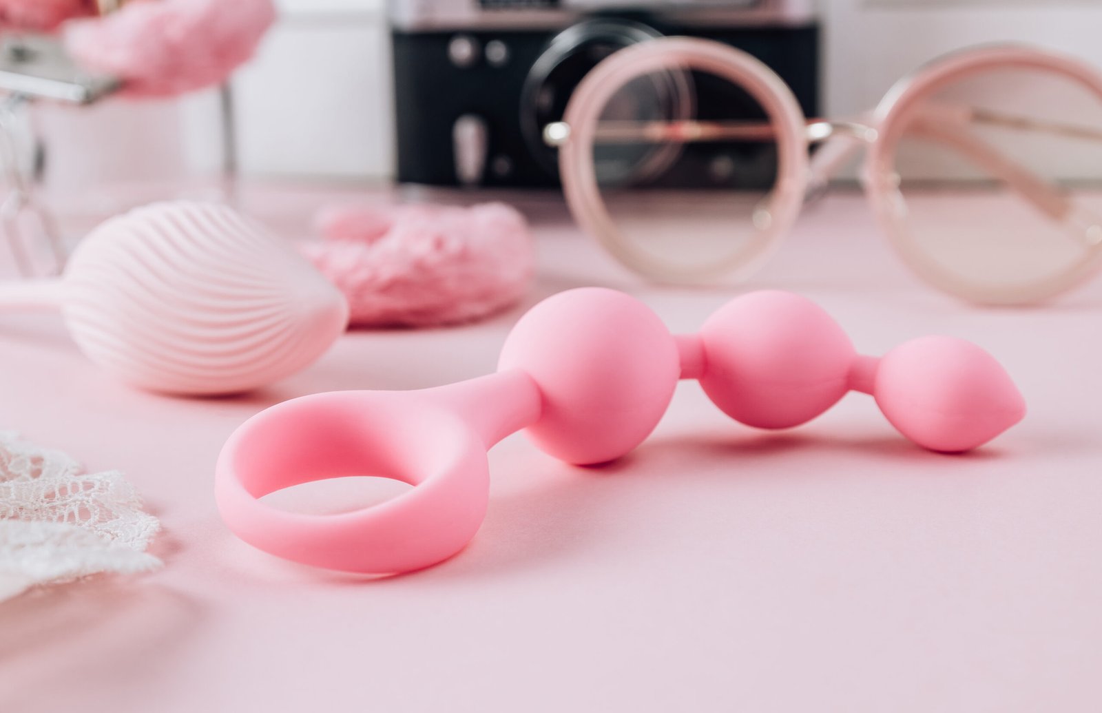 Female pink background with different sex toys. Online store, shopping, delivery, Stay at home concept. Selective focus